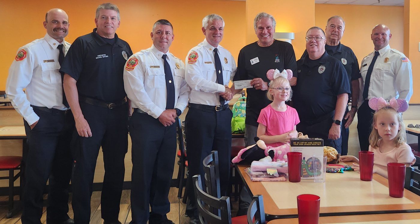 Bartlett Fire Department leaders presenting a check to the Dream Factory of Memphis with Lorelai and her sister