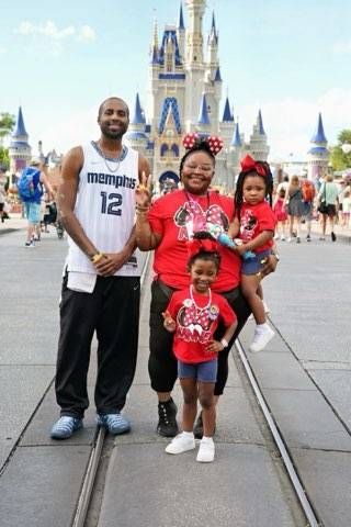 Iylah and her family in front of Cinderella Castle